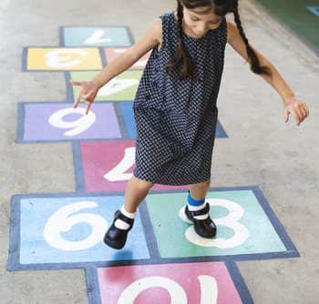 Girl playing hopscotch