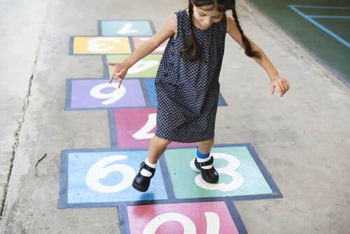 Girl playing hopscotch